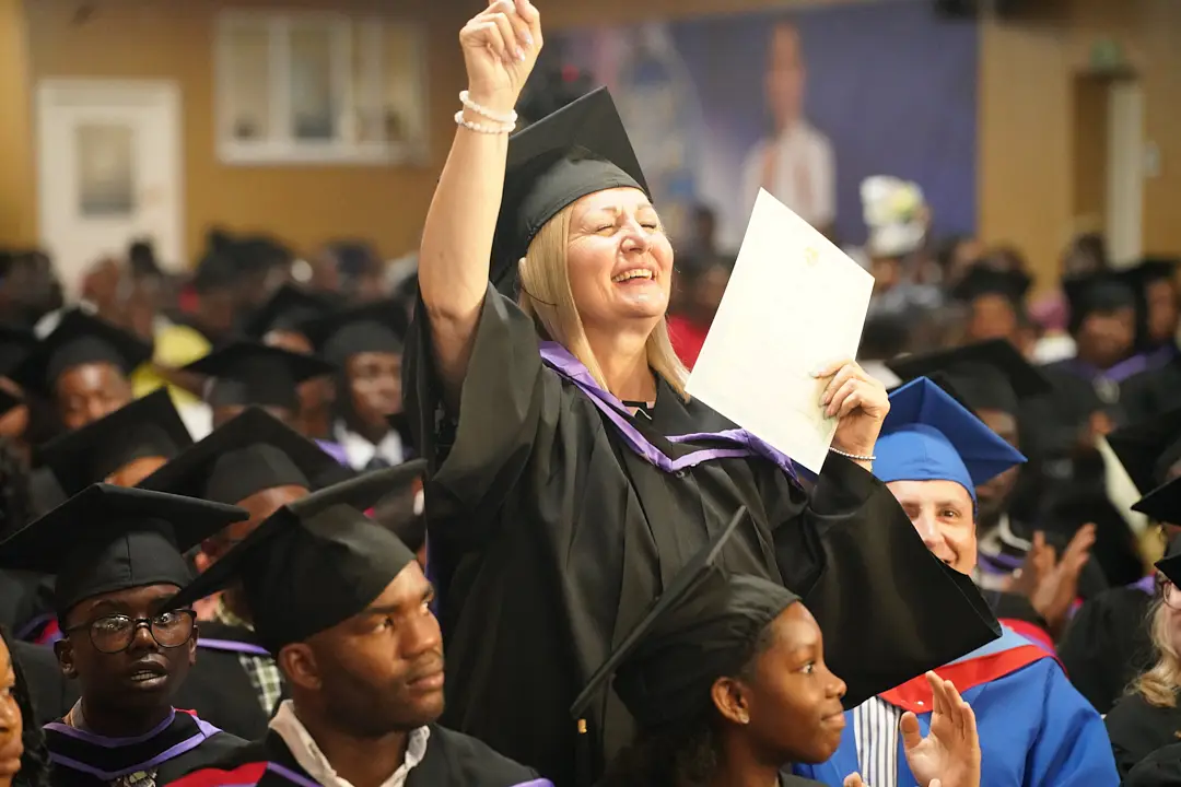 A graduation celebration with students seated in caps and gowns